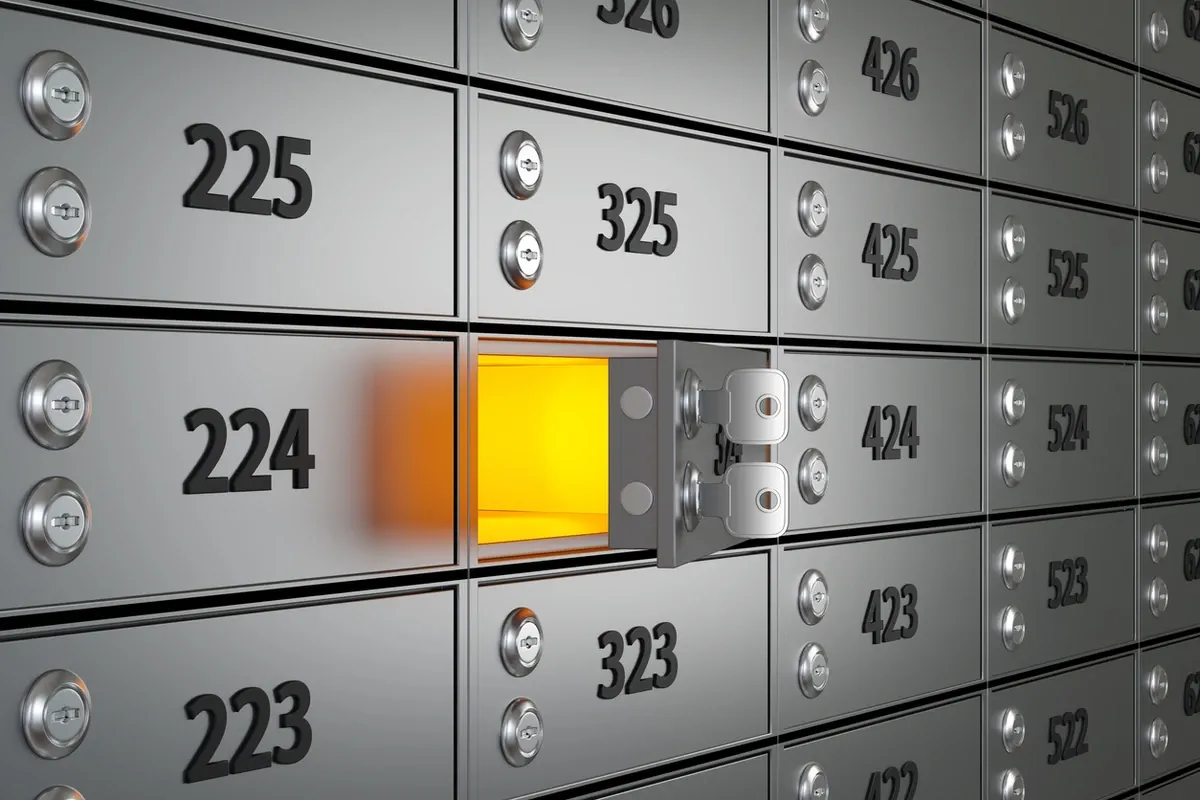 A safe deposit box is opened with two keys in a secure bank vault.