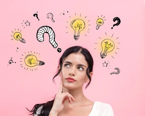 Woman thinking with illustrated light bulbs and question marks around her on a pink background.