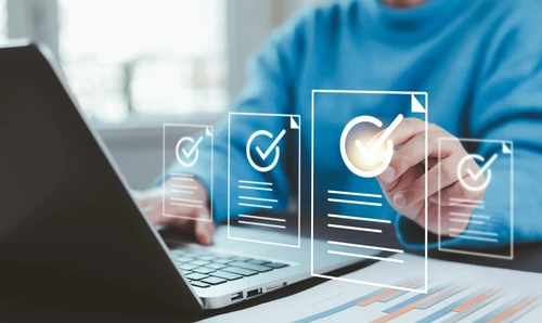Person using a laptop to review options and select the best choice from digital documents.